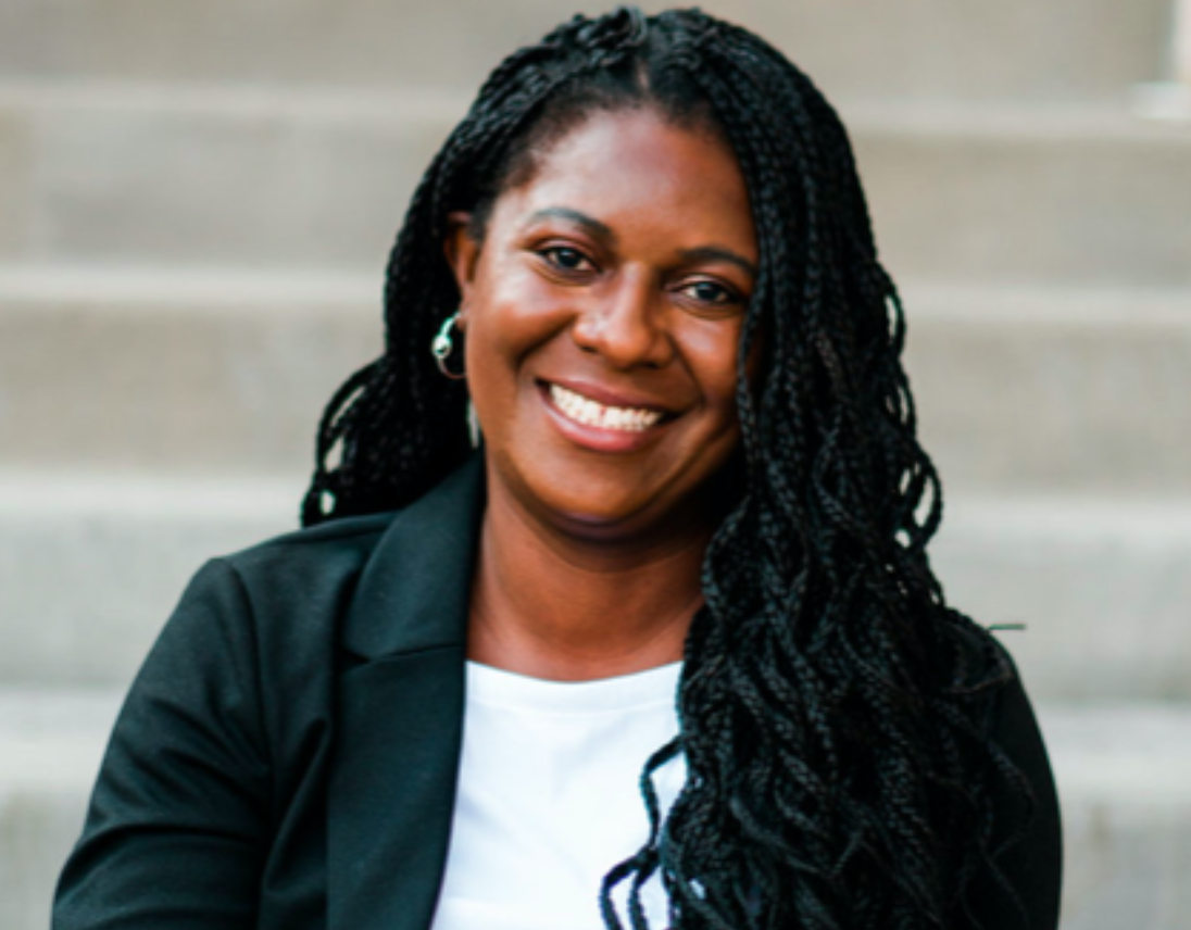 Apryl Alexander, a Black woman with her long hair in braids.